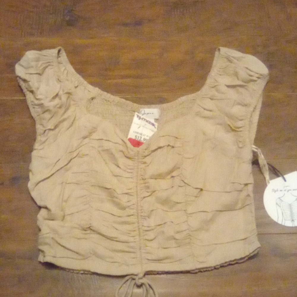 Light tan. Sleeveless. Crop top.